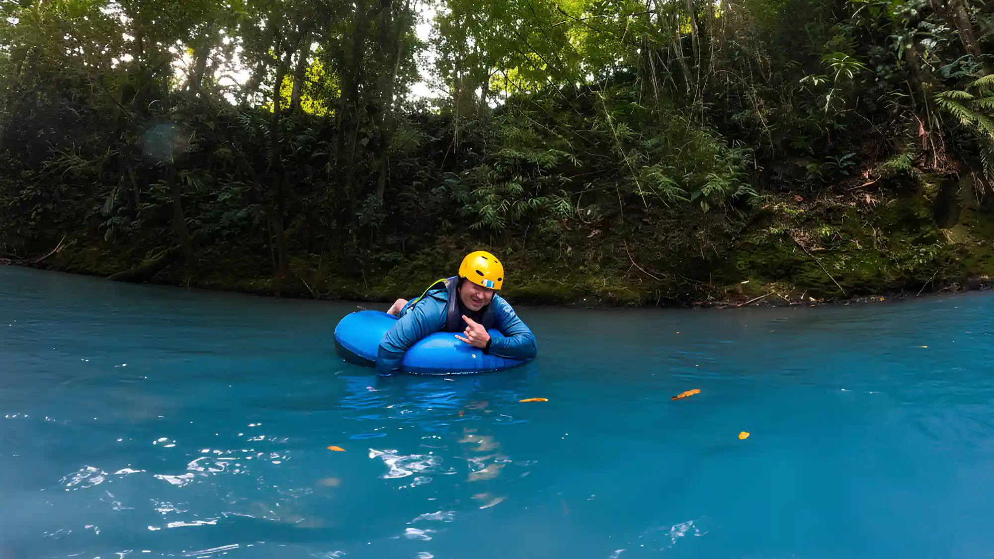 Swimming in a private section of the blue Rio Celeste river during trail ride