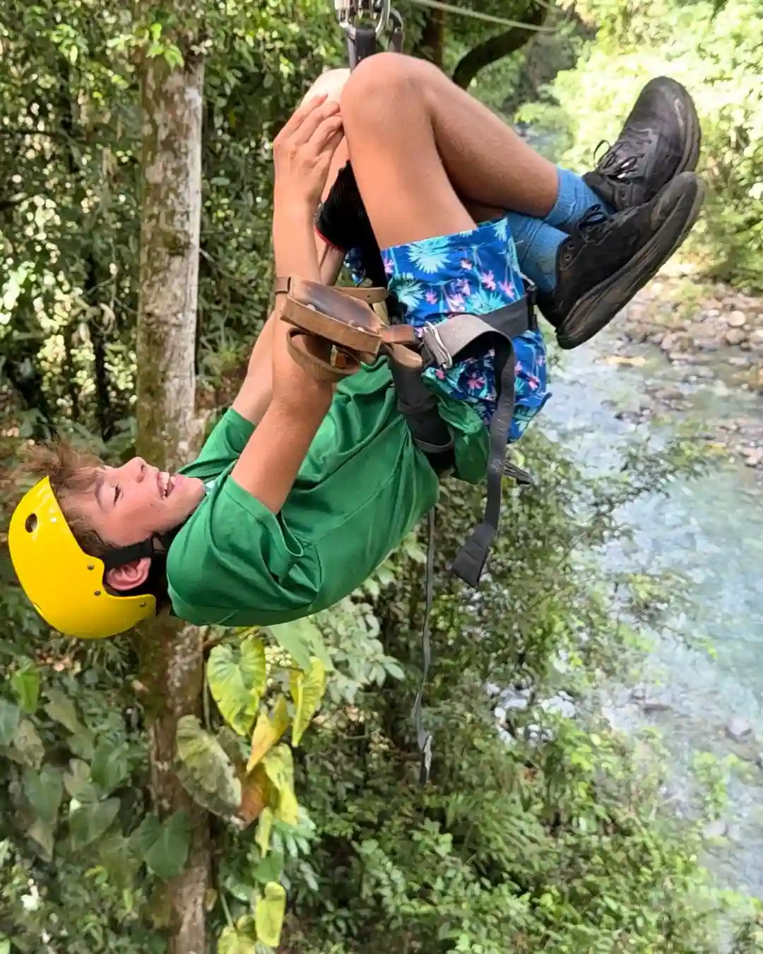 Happy kids wearing safety harnesses participating in a family friendly private ziplining tour