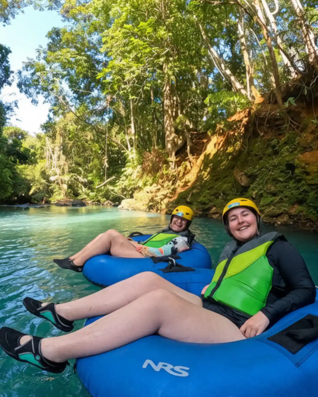 Mother and daughter floating on a private Rio Celeste tubing tour near Tenorio Volcano